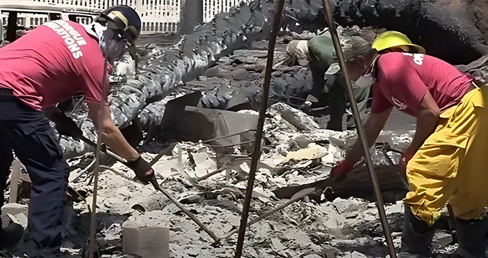 A group of people working on the rubble.